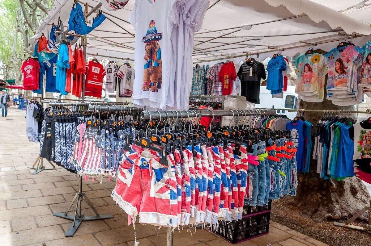 T-shirts and shorts for sale under a tent
