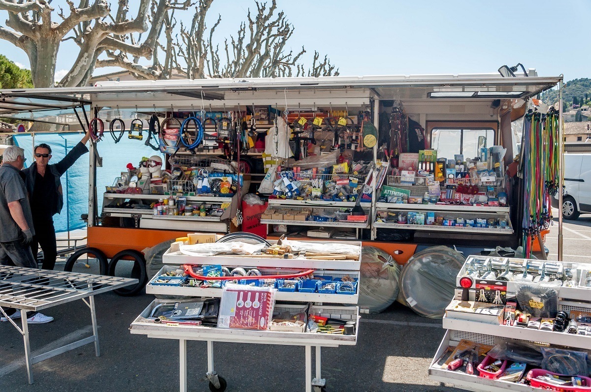 Housewares for sale displayed on outdoor tables and kiosks