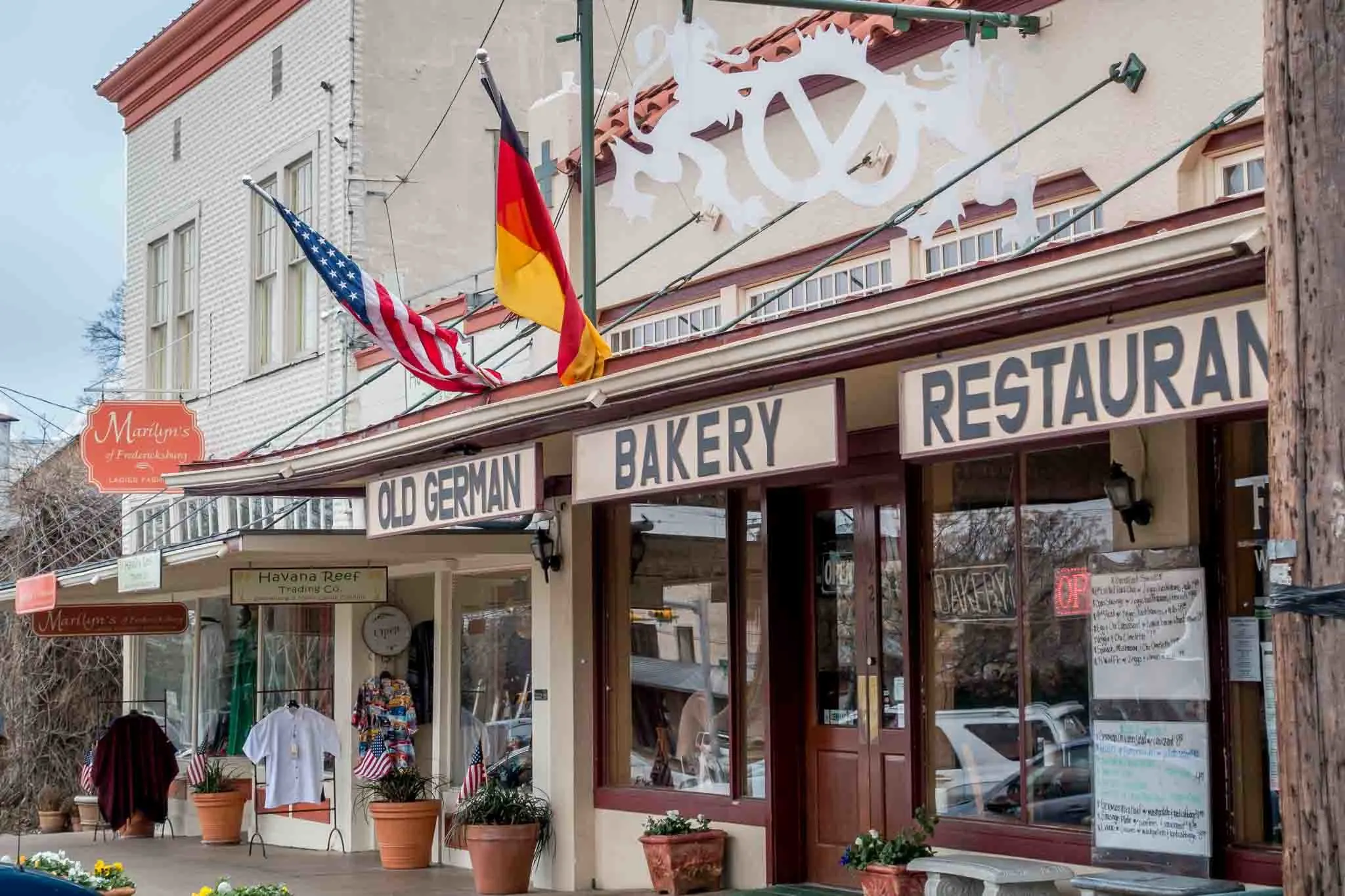 Storefront for Old German Bakery & Restaurant flying German and American flags
