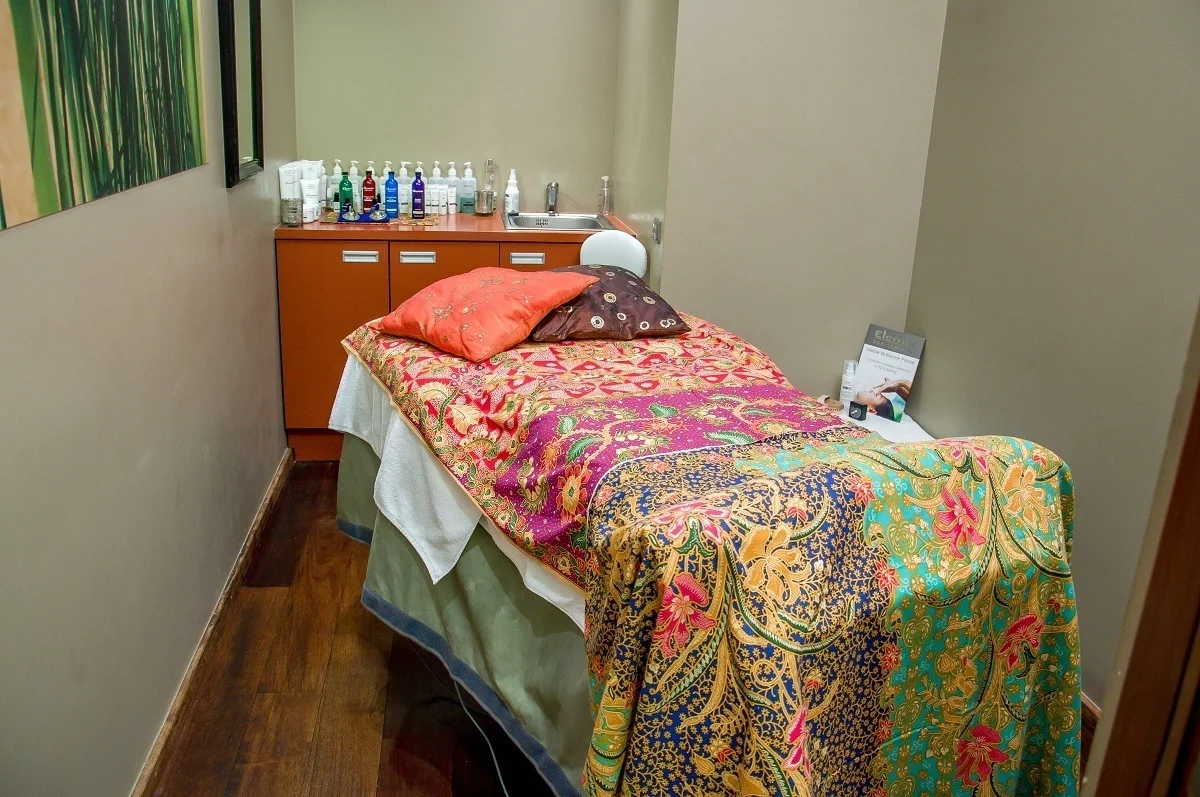 Spa treatment room with bed and spa products
