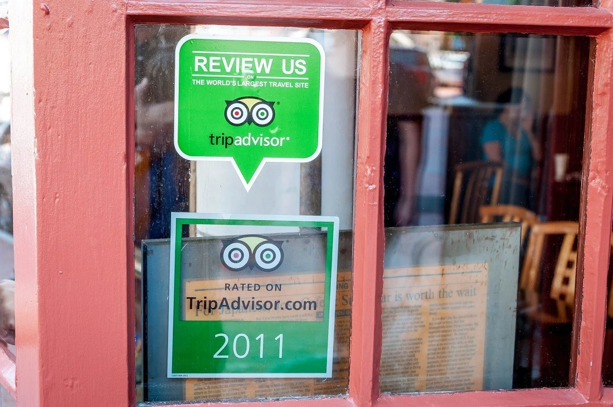 Decals in windows promoting TripAdvisor reviews
