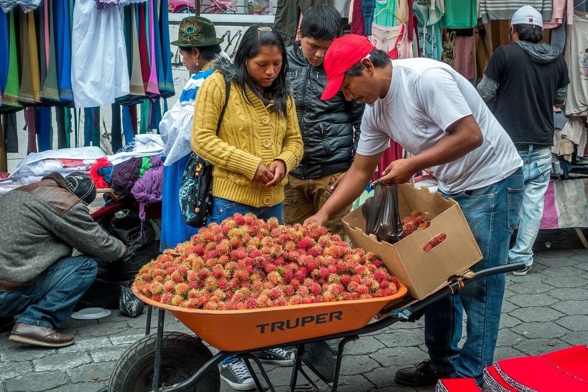 Man selling fruit in the Otavalo market