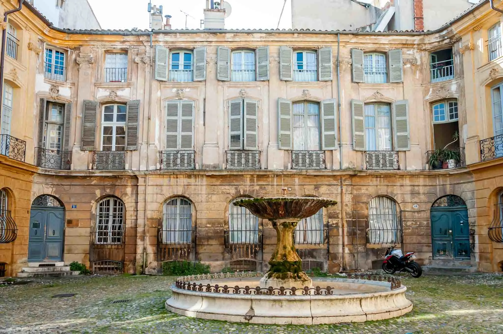 Fountain in a courtyard surrounded by buildings in Aix-en-Provence France