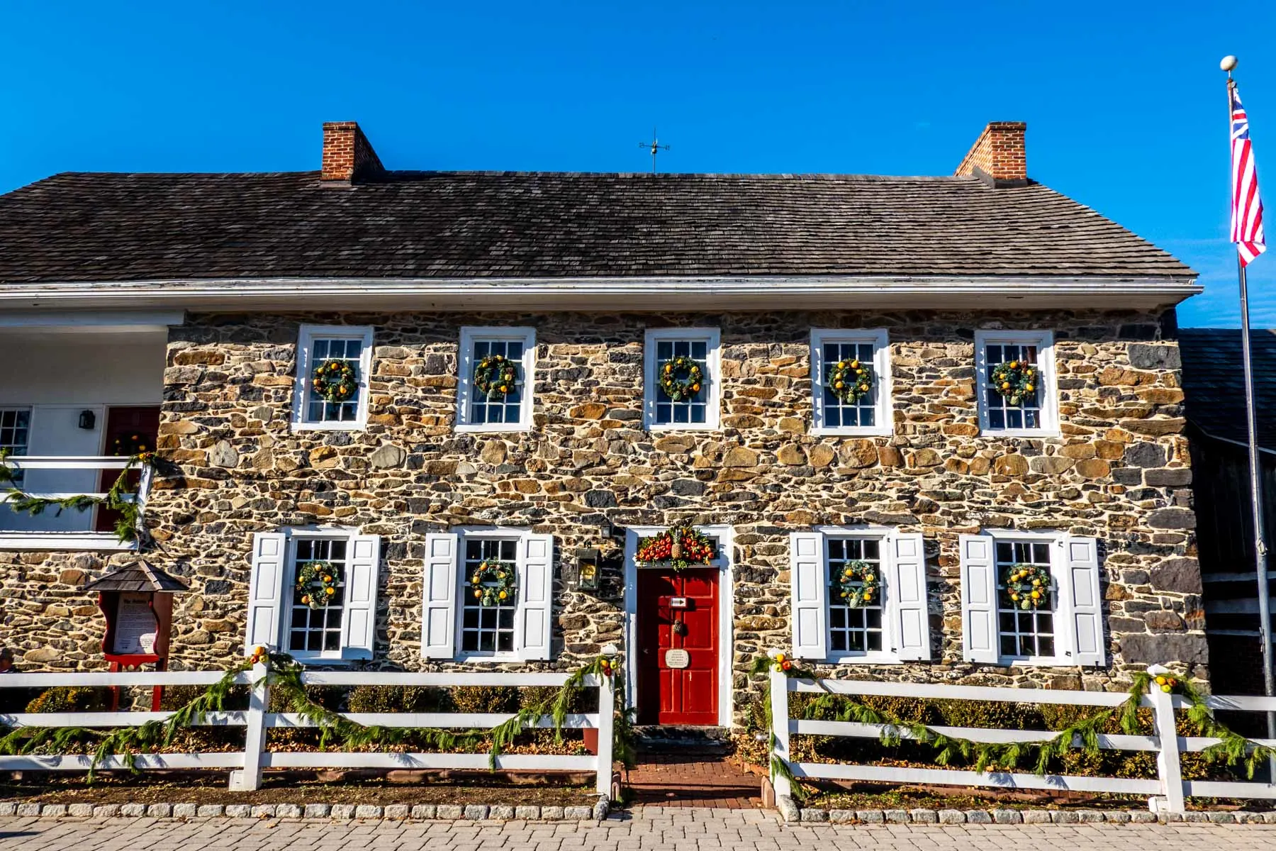 Stone exterior of the Dobbin House decorated with Christmas wreaths