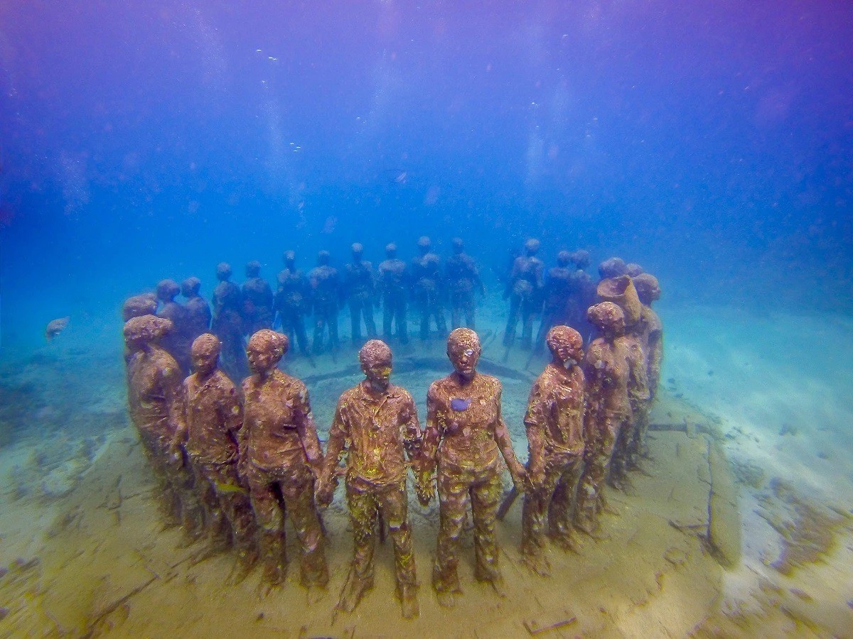 Underwater sculptures of people in a circle off the coast of Grenada