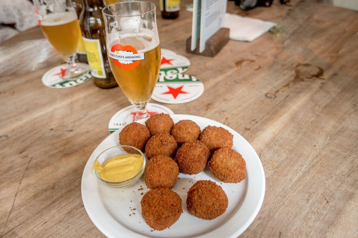 Bitterballen with mustard on a plate and a pint of beer
