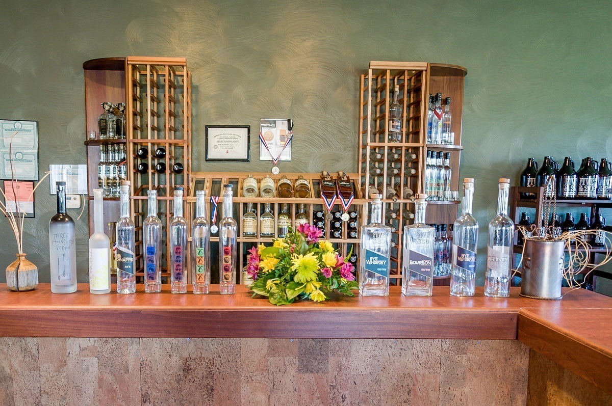 Spirits and wine bottles on display at a tasting bar
