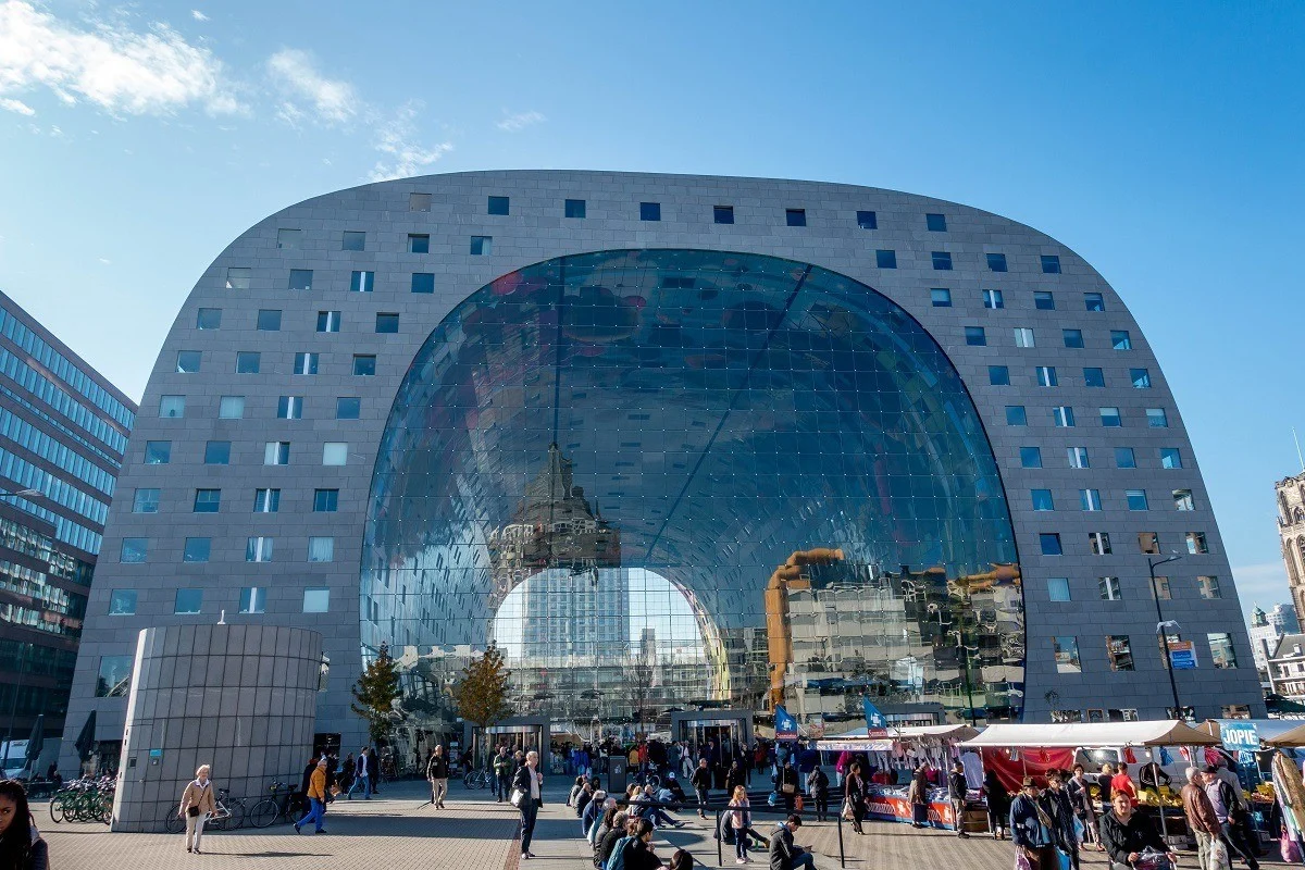 Exterior of Rotterdam's Market Hall, large arch-shaped building with glass walls