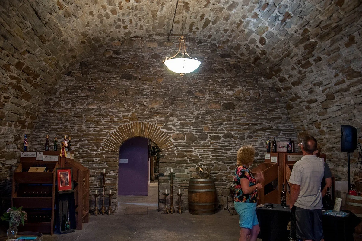 People in stone wine cellar
