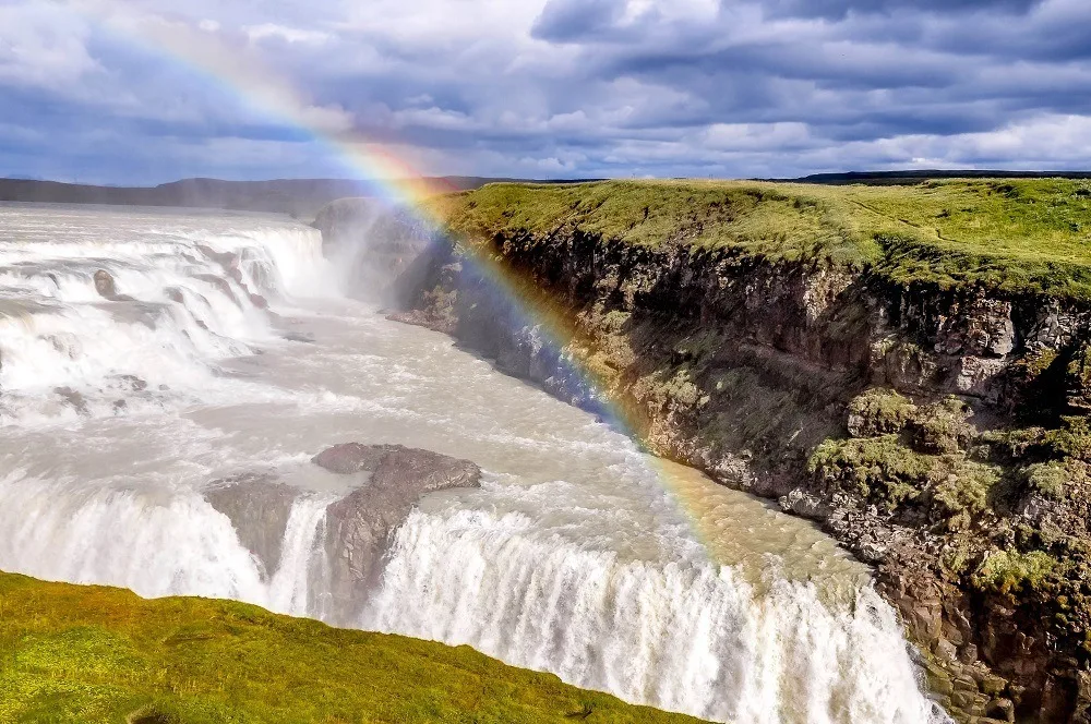 Rainbow over a large waterfall.