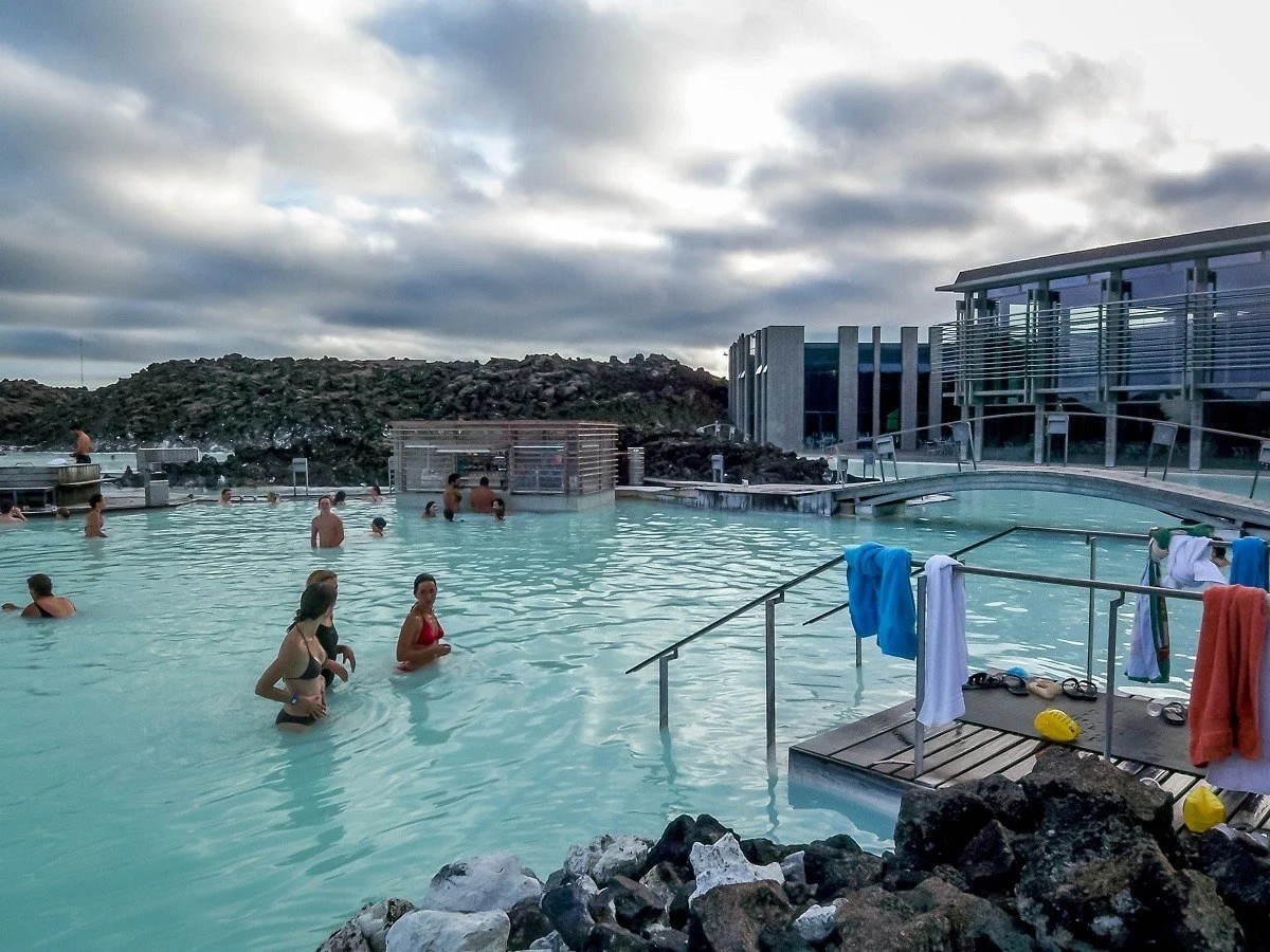 People swimming in bright turquoise water.