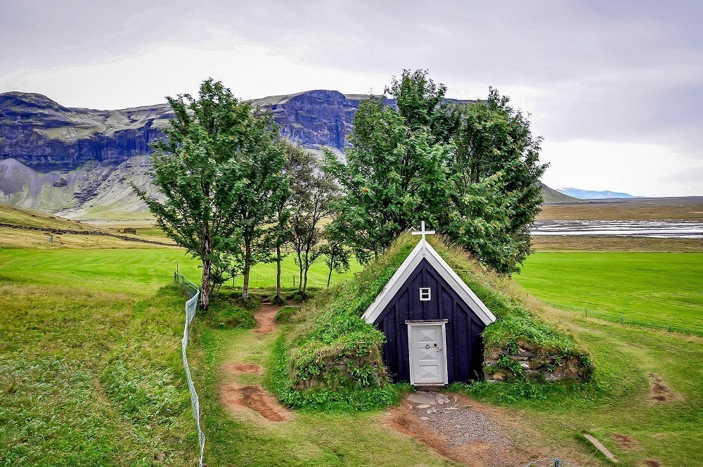 A green turf church in the Iceland countryside.