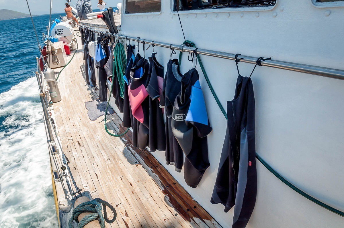 Wetsuits drying on the deck of the Beagle after snorkeling