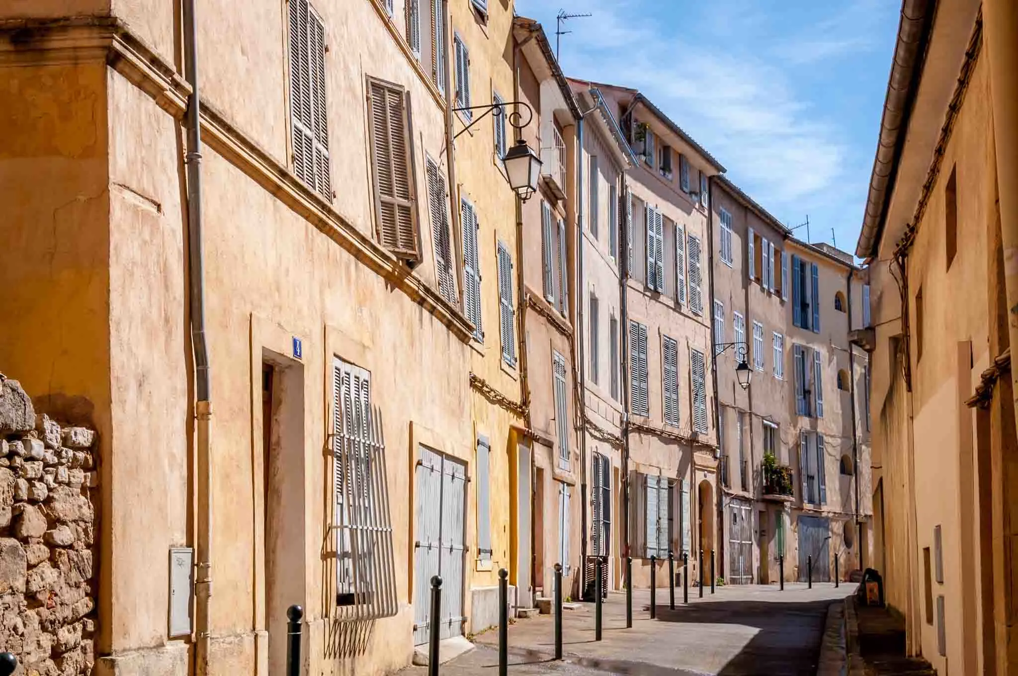 Peach and yellow buildings along a street in Aix-en-Provence France