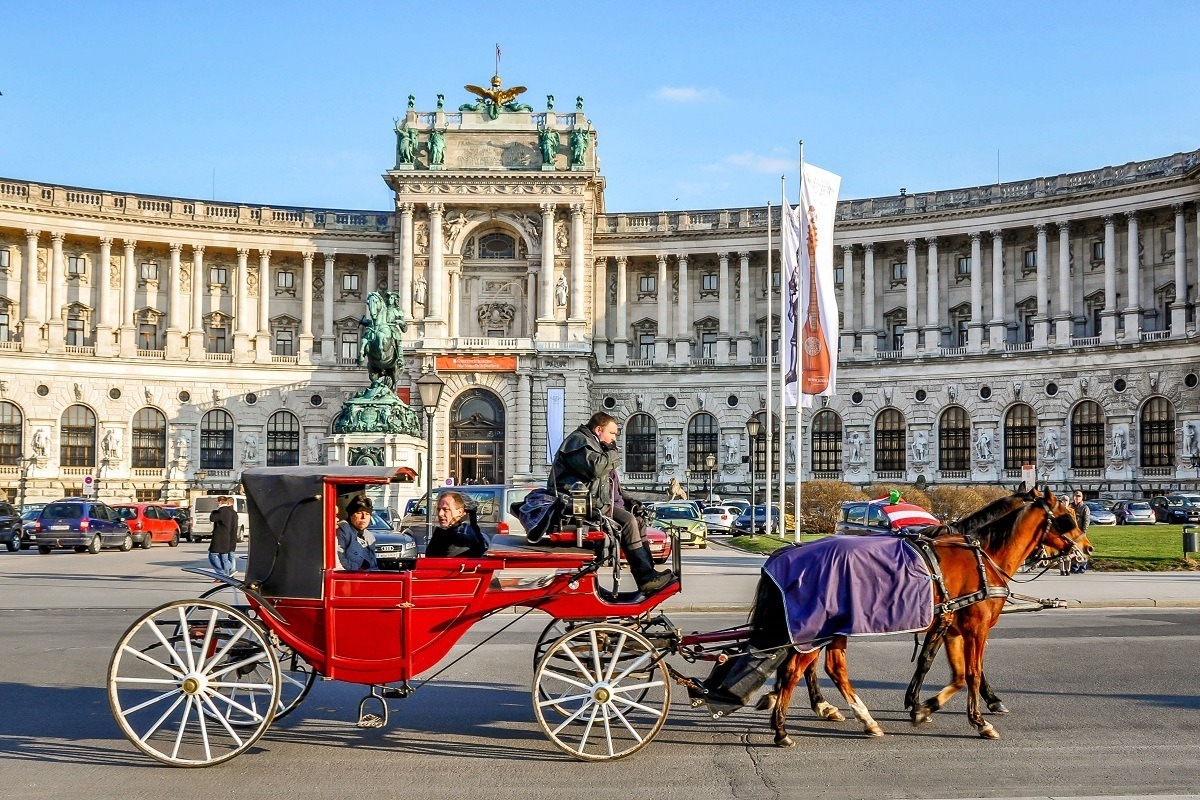 Horse-drawn carriage in front of Hofburg Palace in Vienna, Austria