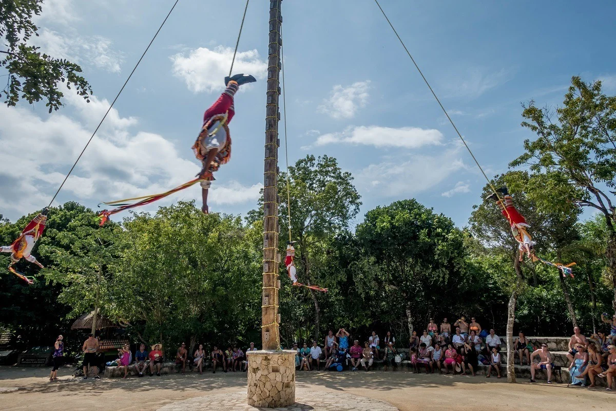 Men hanging and spinning on ropes