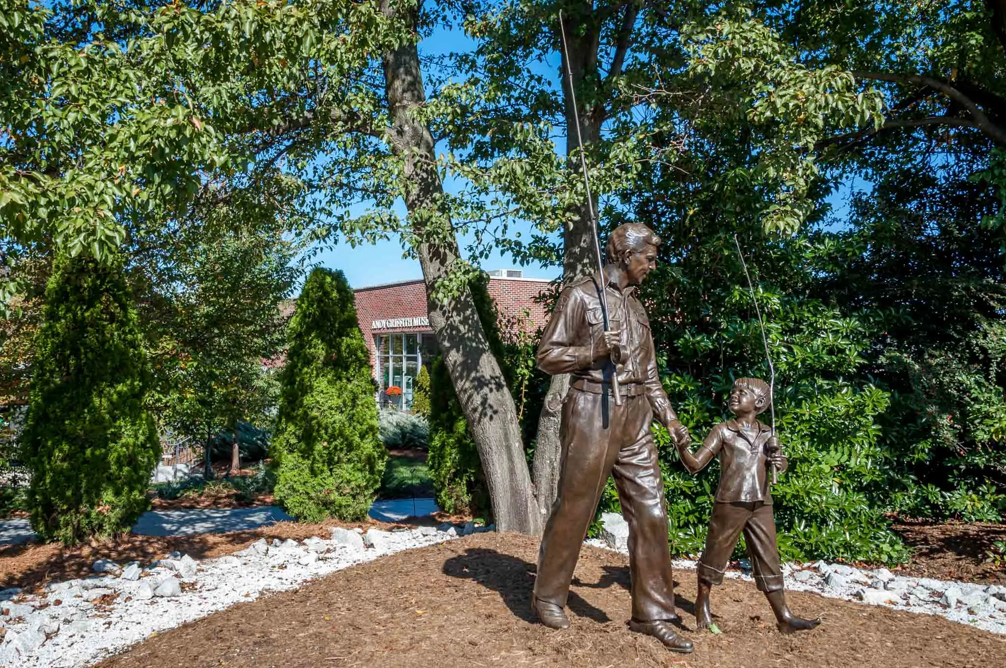 Statue man and boy with fishing poles