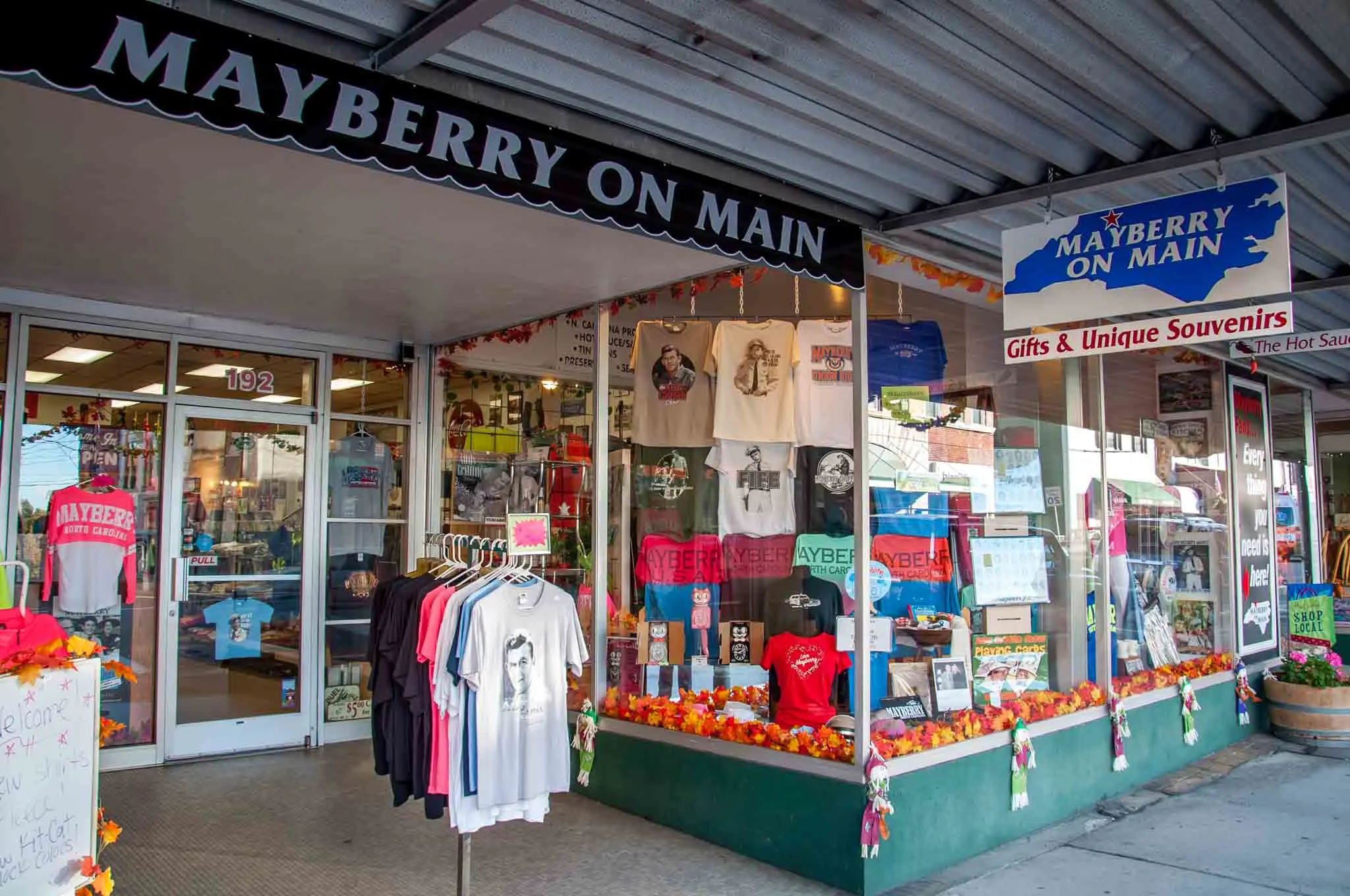 T-shirts in storefront of Mayberry on Main, a souvenir shop. 