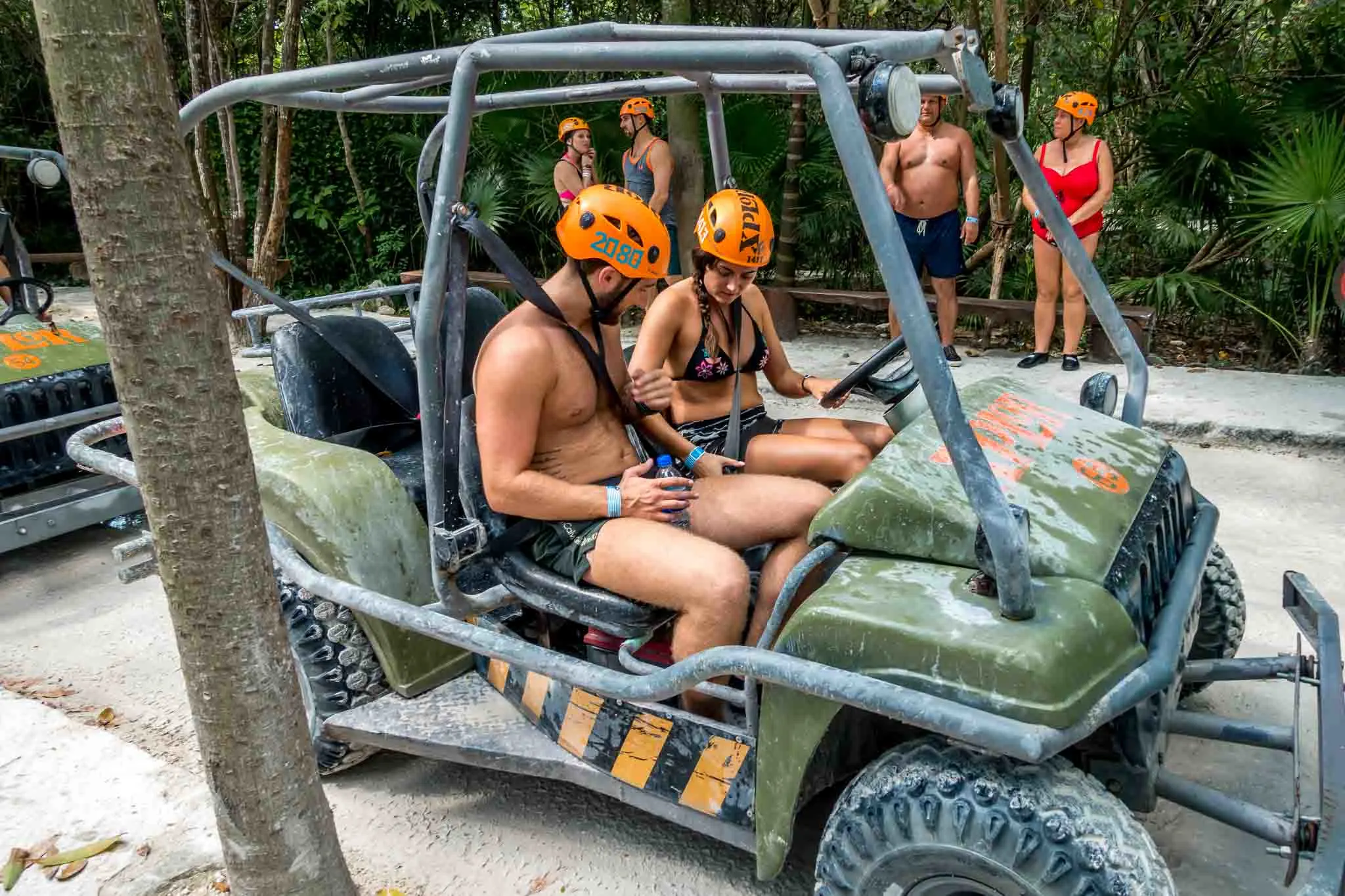 People fastening seatbelts in their amphibious vehicle