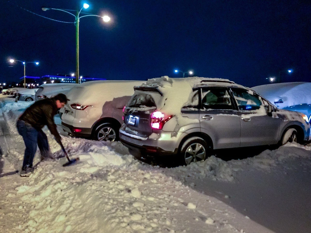 Digging out a car after a blizzard
