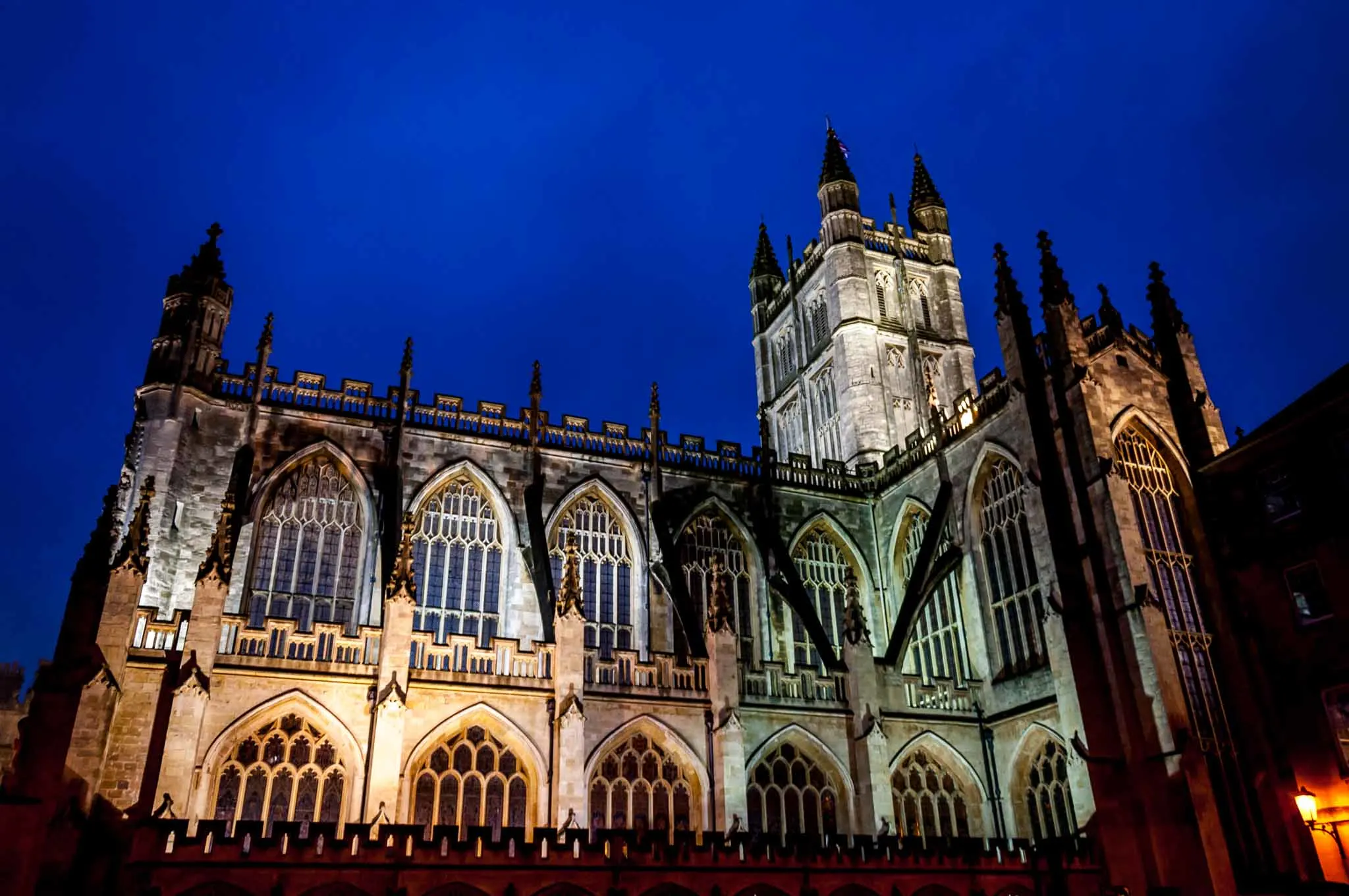 Gothic cathedral lit in colorful lights at night, the Bath Abbey.