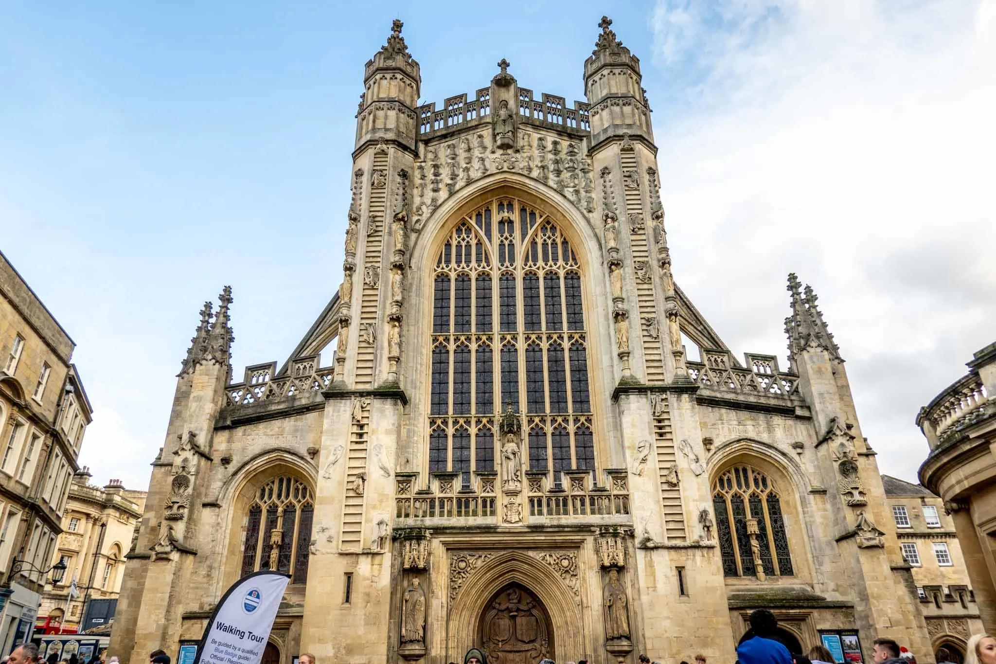 Outside of Bath Abbey showing its stained glass windows and arches.