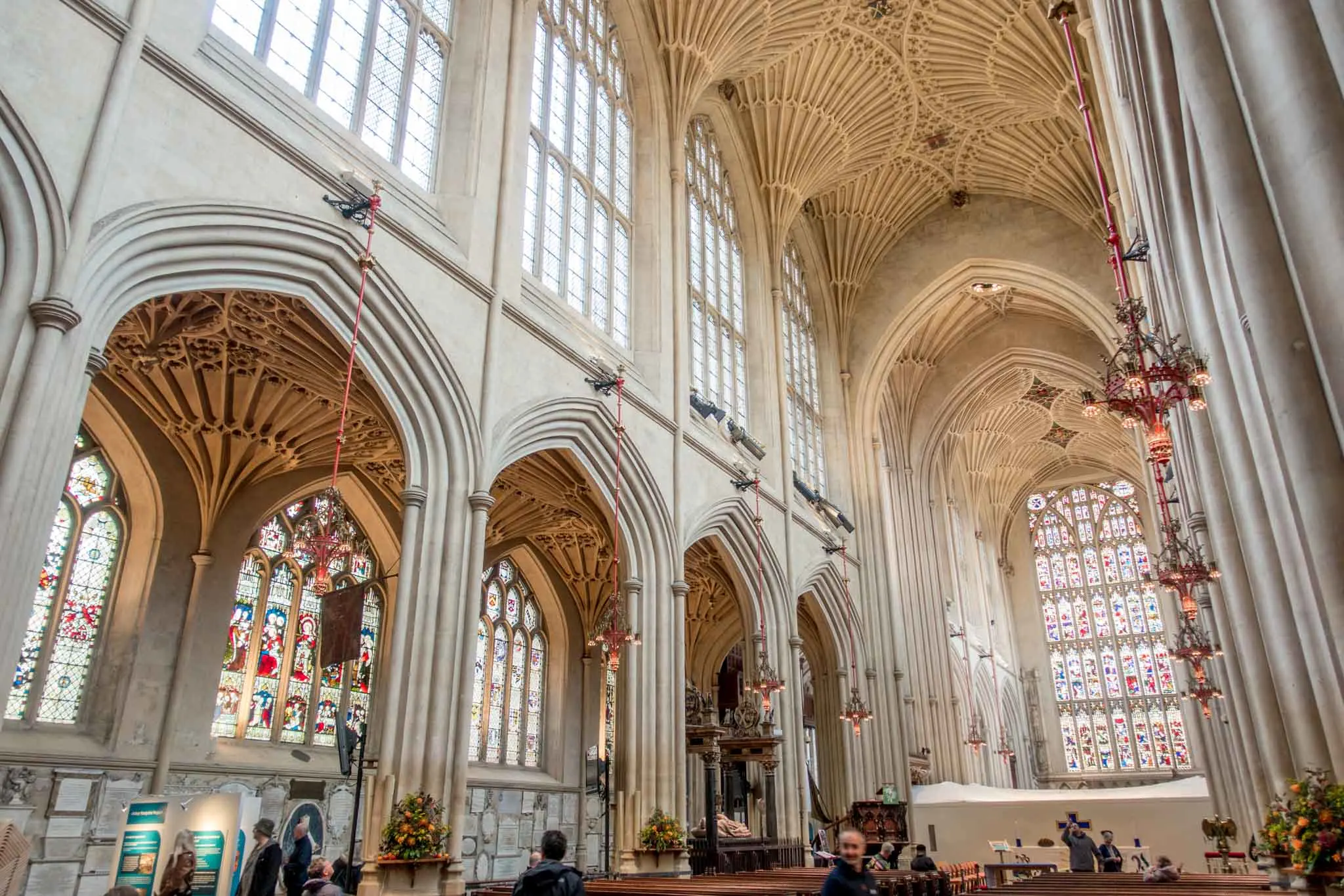 Stained glass windows and vaulted ceilings inside Bath Abbey in England