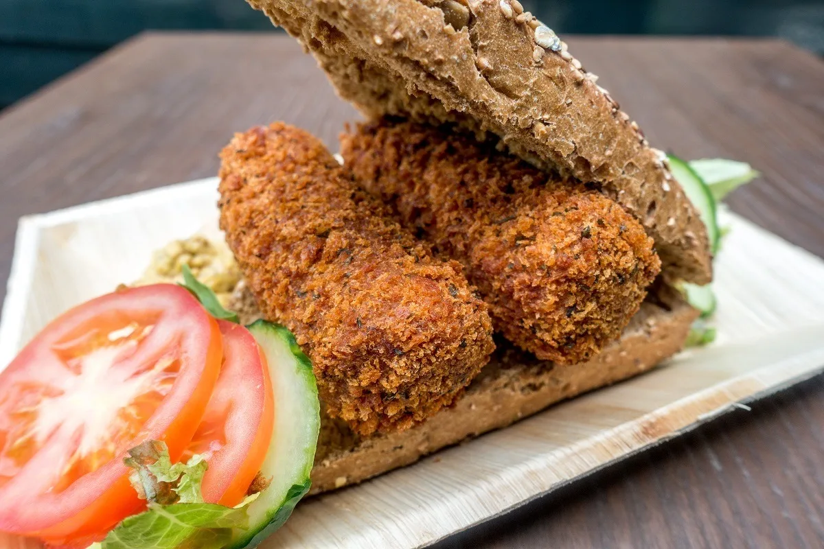 Croquettes on a roll with tomato