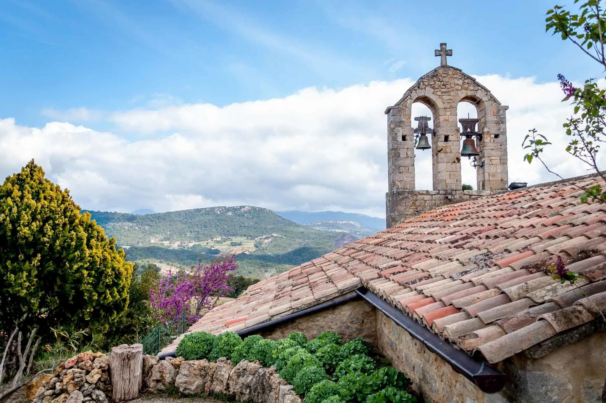 Hilltop church with a bell tower.