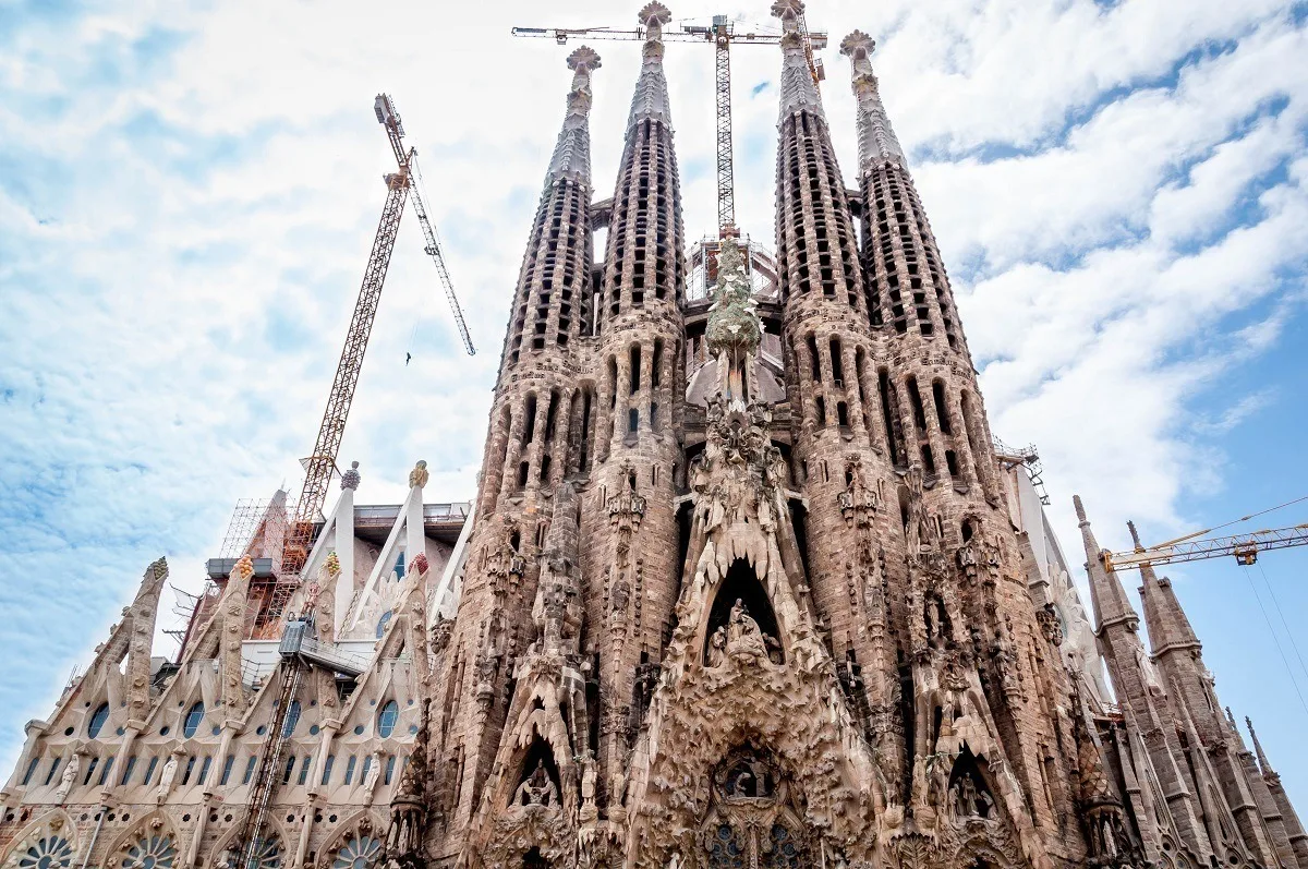 Building with numerous towers and carved decorations, the Sagrada Familia