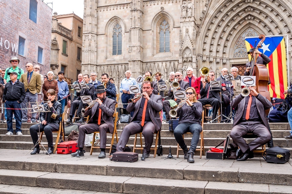 Musicians playing horns on the steps of Barcelona Cathedral
