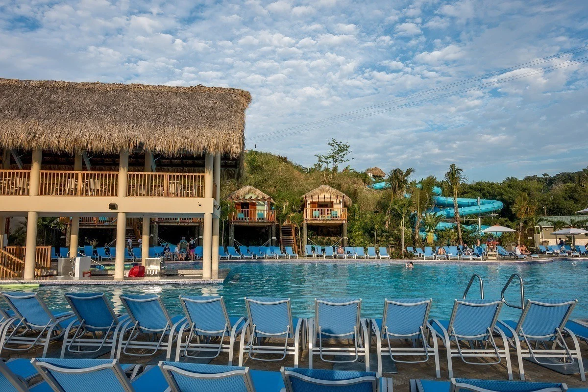 Pool lined with lounge chairs and swim up bar