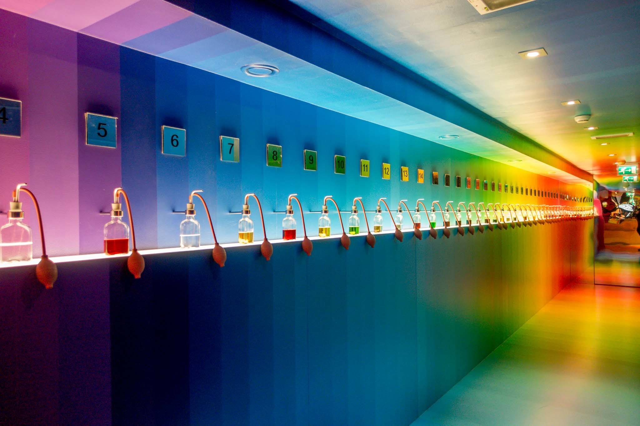 Rainbow colored exhibit with jars of colored liquid