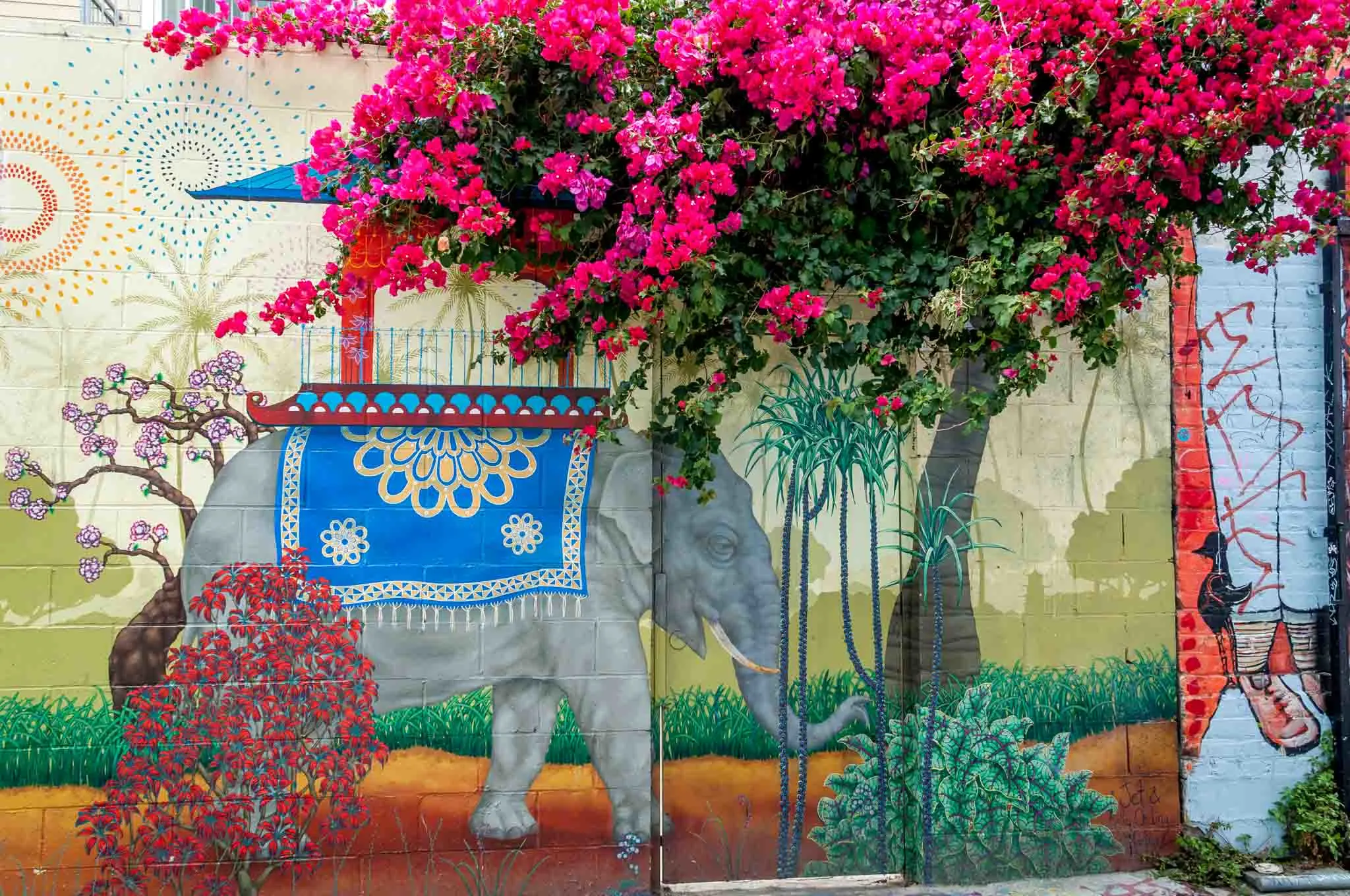 Elephant mural that combines with a tree with pink flowers