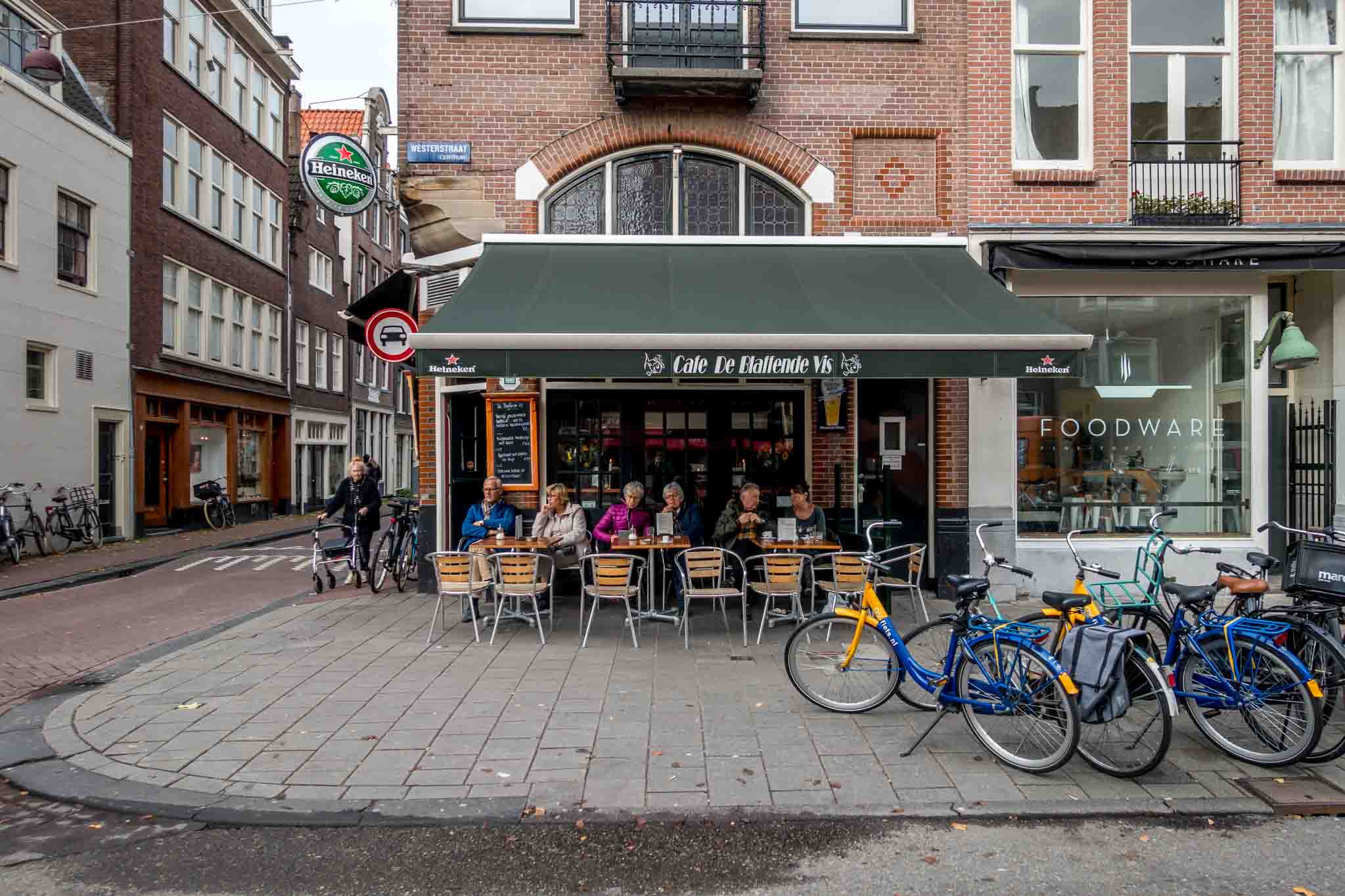 People sitting at a sidewalk cafe.