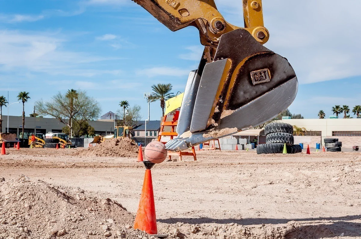 Picking up basketballs with construction equipment