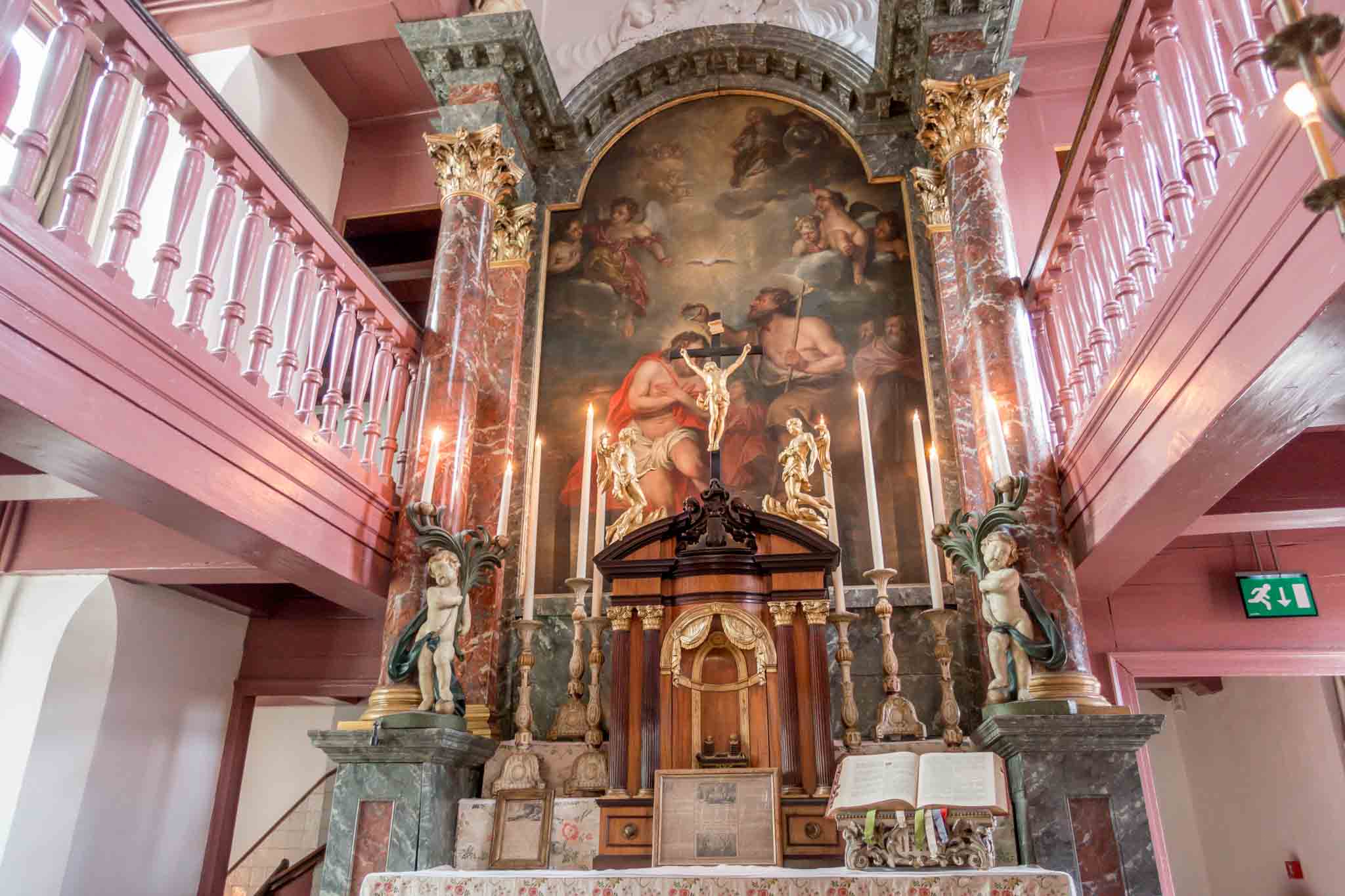Altar and religious painting in a church sanctuary.