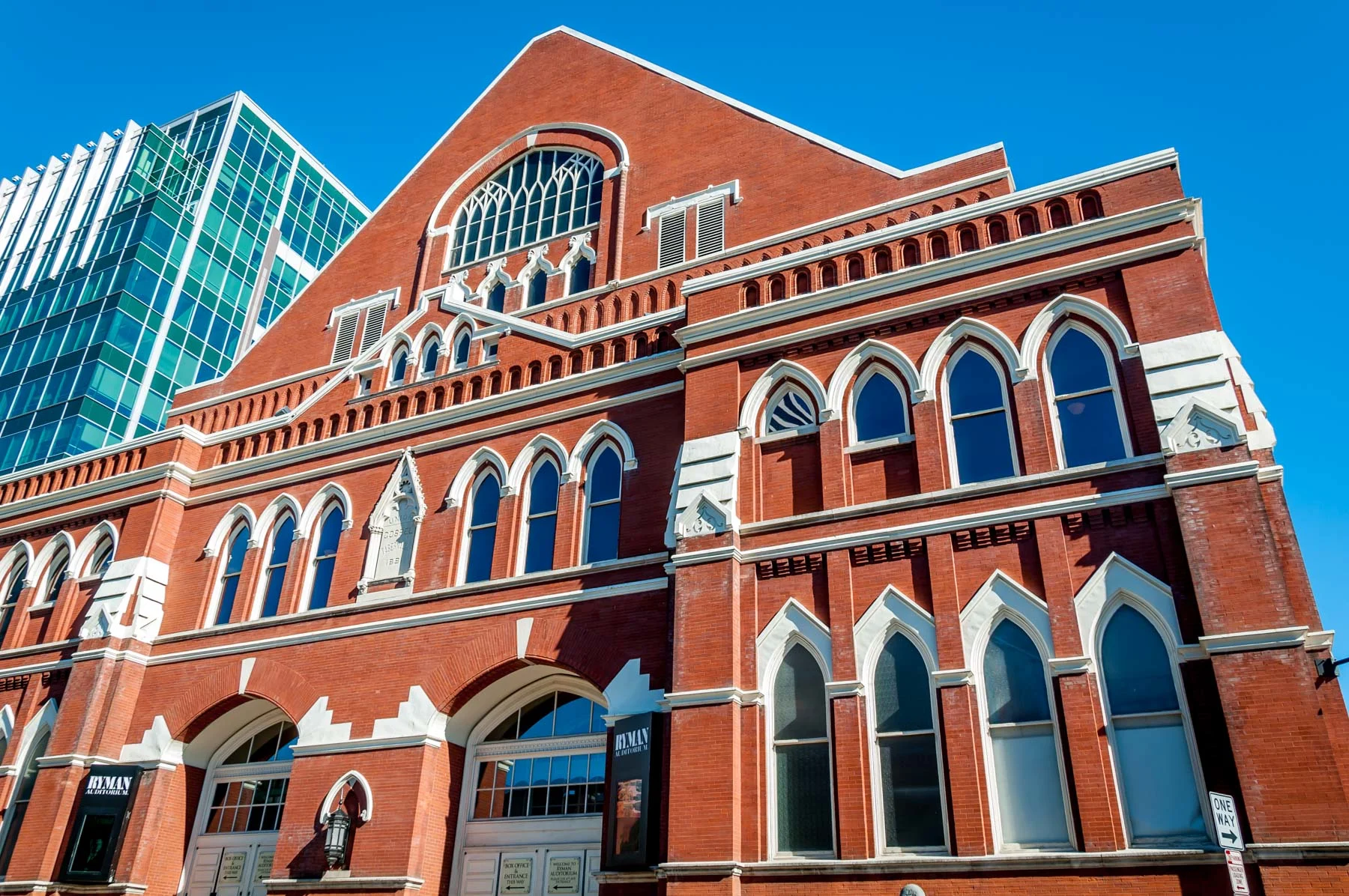 Exterior of red brick building with arched windows.