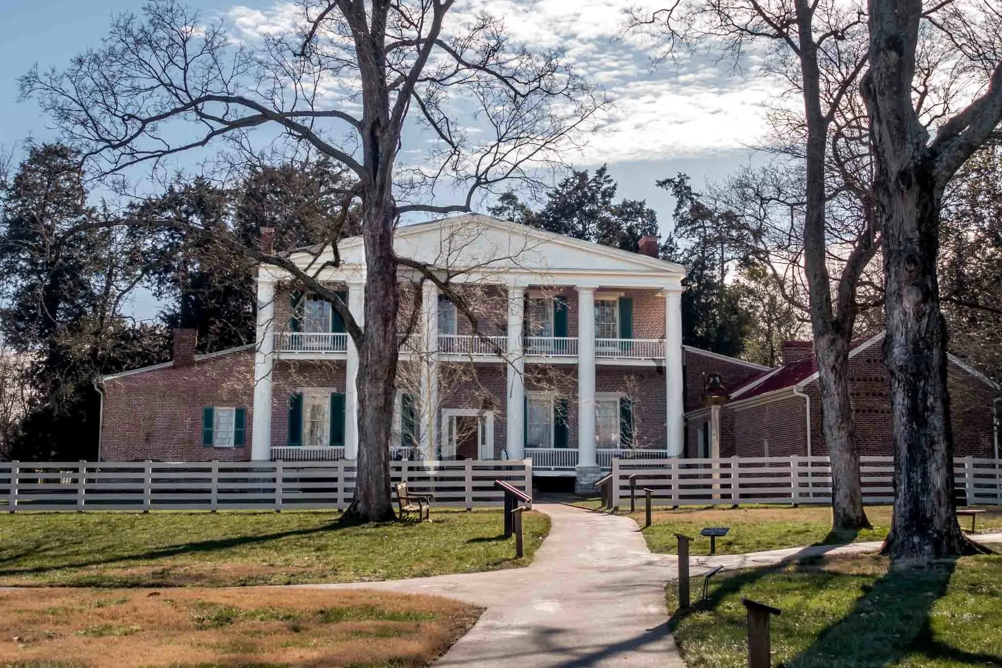 Exterior of a 2-story brick home with white columns.