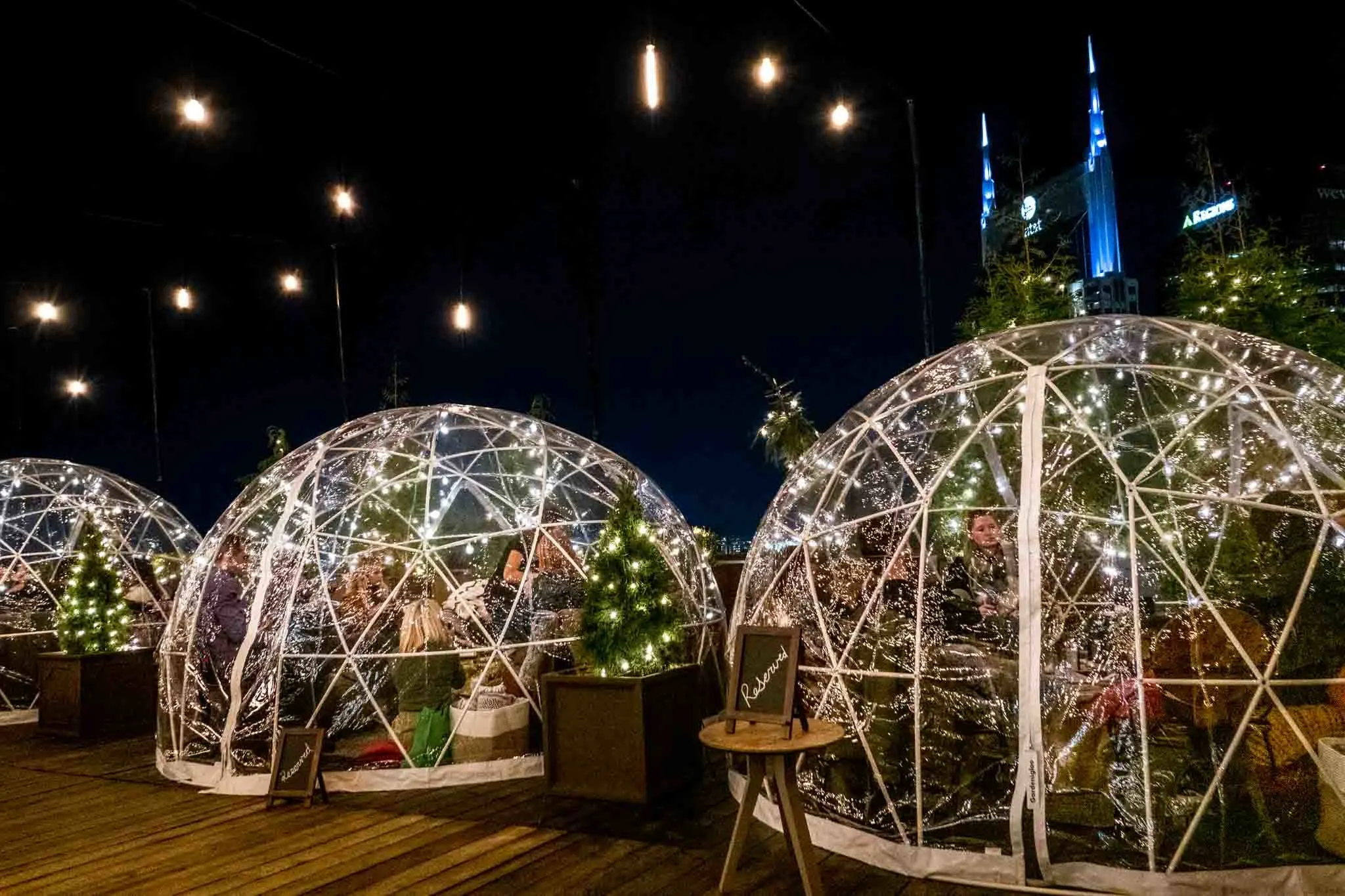Igloo tents at night on a deck