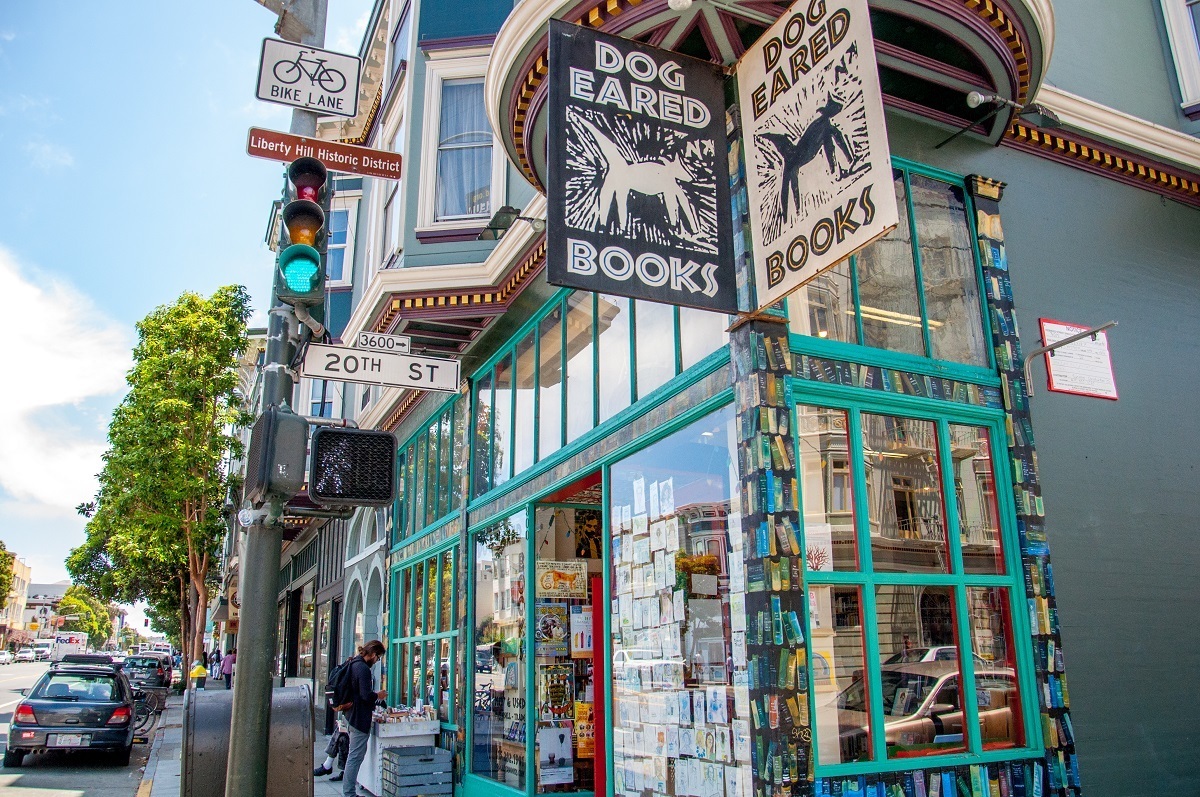 Exterior of Dog Eared Books bookstore with signage.