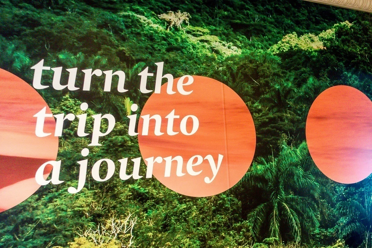 "turn the trip into a journey" -- a poster reminder on Adonia