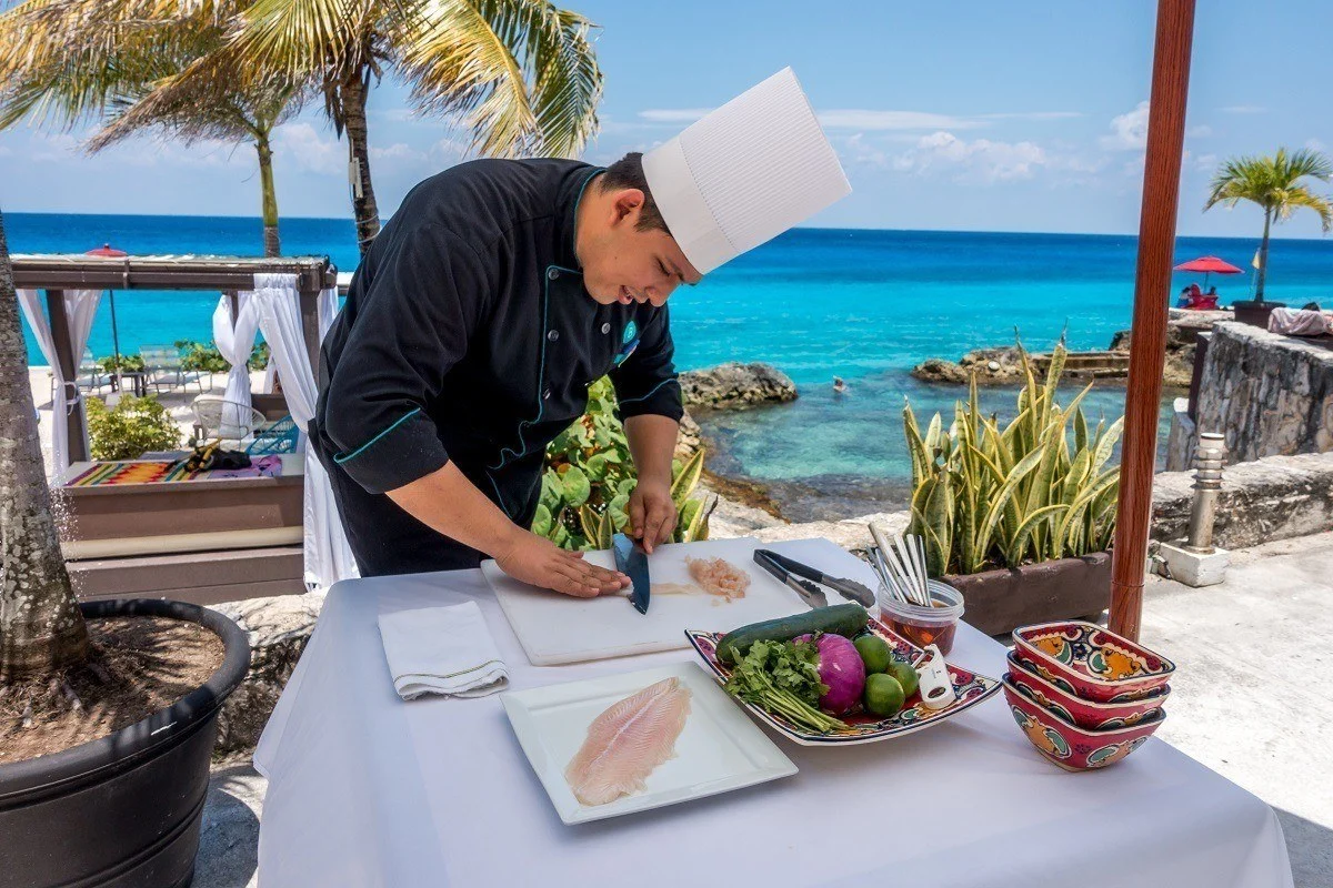 Chef cutting fish for ceviche by the ocean