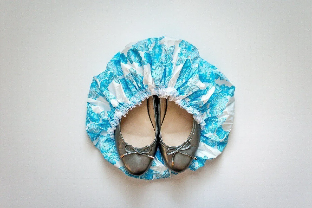 Shoes covered by shower cap