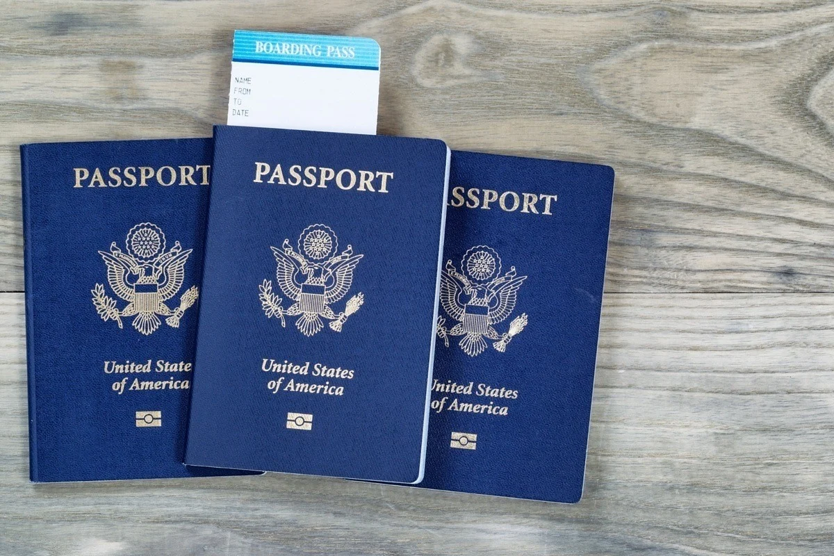 Three passports with a boarding pass for an international trip