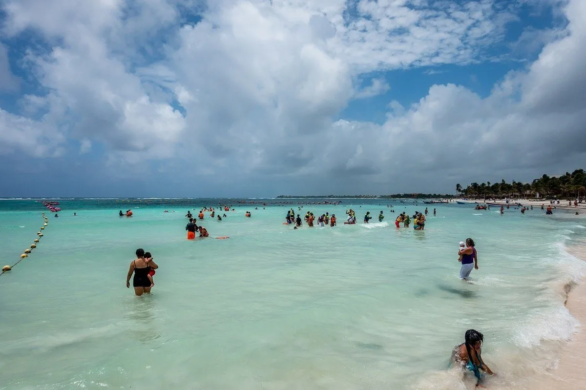 Buoyed section of ocean with groups of snorkelers and swimmers