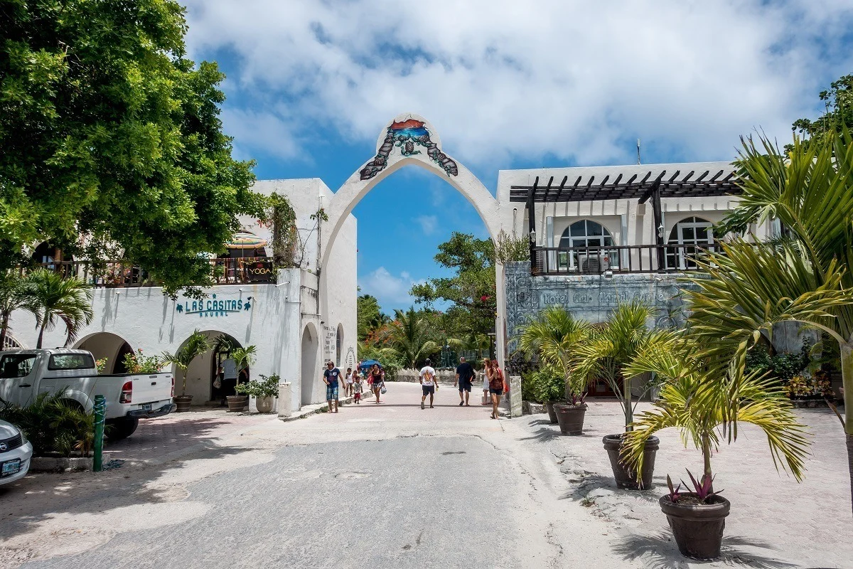 People walking through the main entrance gate to Akumal, Mexico