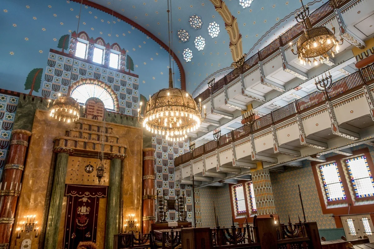 Graphic designs and chandeliers inside a synagogue
