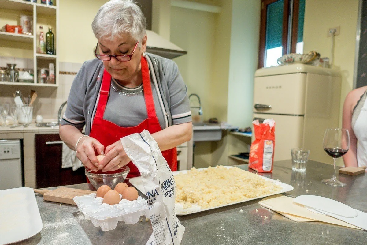 Woman cracking eggs to make gnocchi