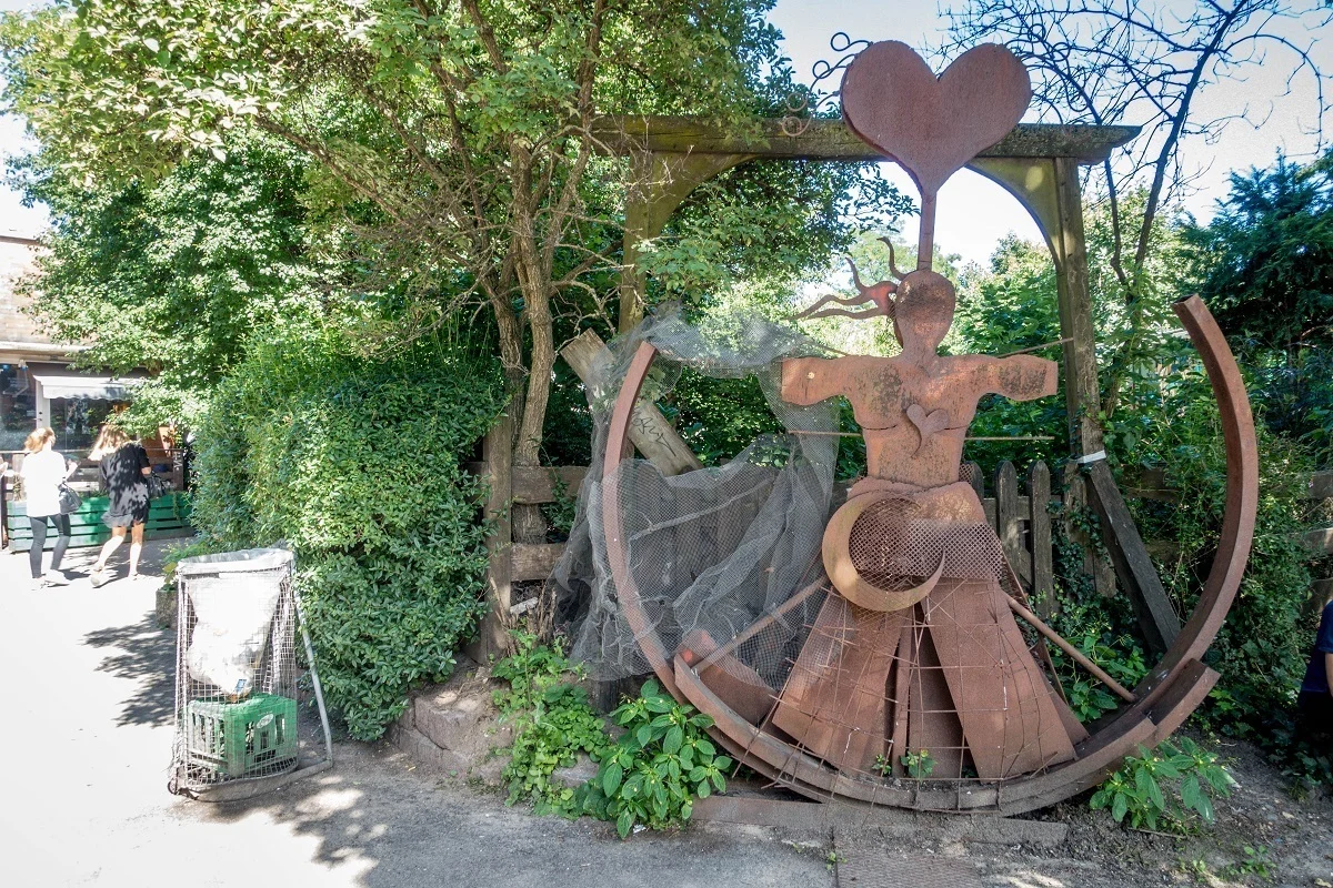 Metal artwork of a person with heart over its head